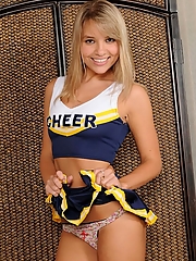 Blonde cheerleader strips uniform to show tan lines